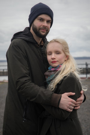 Charming young woman with blond hair and handsome man outdoors. Happy coupleの写真素材
