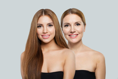 Perfect young model woman and mature woman. Two female faces collage set. Old and young faceの写真素材