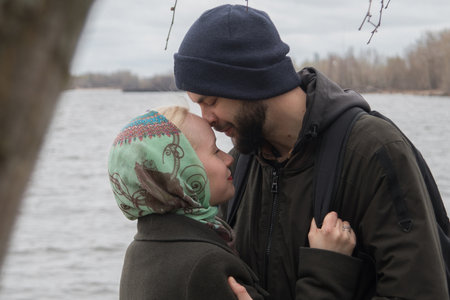 Kissing couple. Man and woman in love, outdoors lifestyle portraitの写真素材
