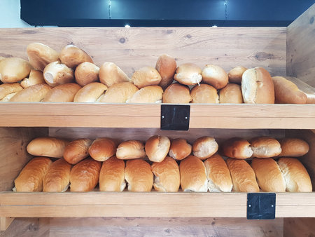 Freshly traditional baked bread on shelf in bakery shop closeupの写真素材