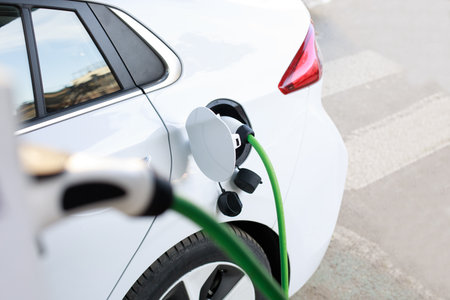Electric car recharging in charging stationの写真素材