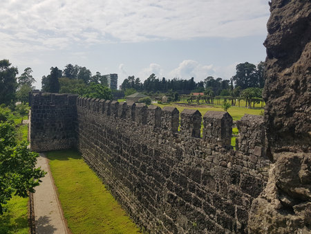 Stone wall of an ancient roman fortress on a sunny day with clouds in the skyの写真素材