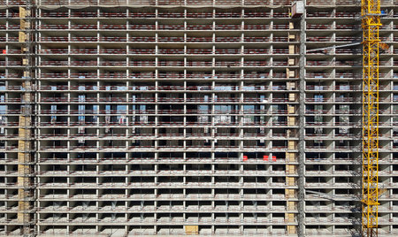 Construction Site of a High-Rise Building With Scaffolding and Crane in Downtown Areaの写真素材