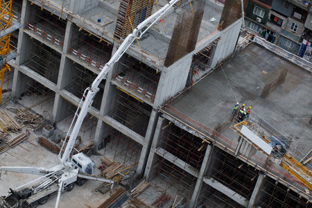 Construction Crew Working with mini spider Crane on Buildingの写真素材
