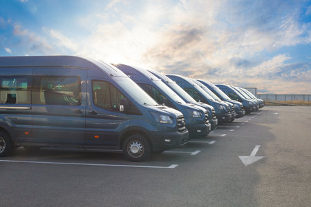 Series of new vans are parked in rowsの写真素材