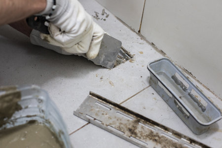 Worker repairs sewer and bathroom drainの写真素材