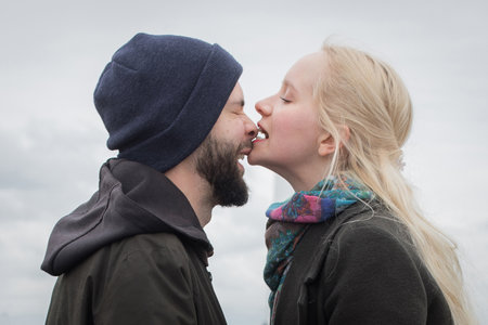 Funny young woman with blond hair and handsome man outdoors. Happy coupleの写真素材