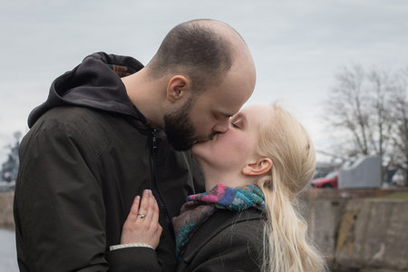 Affectionate man and woman couple hugging each other kissing at seasideの写真素材
