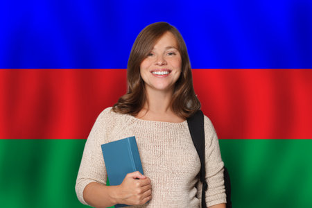 Pretty woman student against Azeri flag background. Travel, education and learn language in Azerbaijan conceptの写真素材