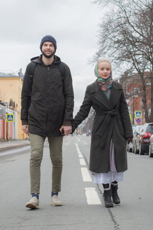 Nice woman and man walking in the park. Beautiful young couple outdoors portraitの写真素材