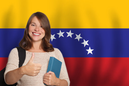 Confident woman student against Venezuelan flag background. Travel, education and learn language in Venezuela conceptの写真素材