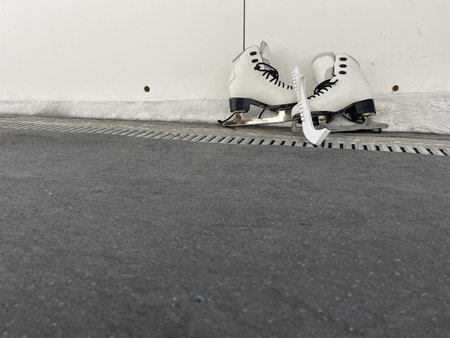 skates with skate blade guards near the ice arena