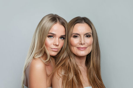 Glamorous young model woman and mature woman. Two female faces collage set. Old and young faceの写真素材