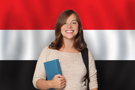 Happy woman student against Egyptian flag background. Travel, education and learn language in Egypt conceptの写真素材