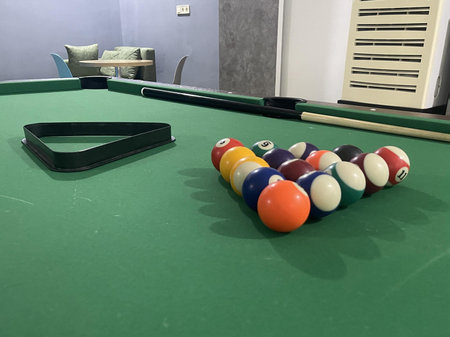 billiard balls with triangle are lying on a billiard table