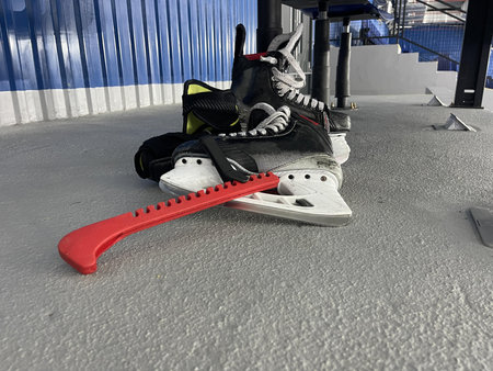 skate blade guard with skates in ice arena floor