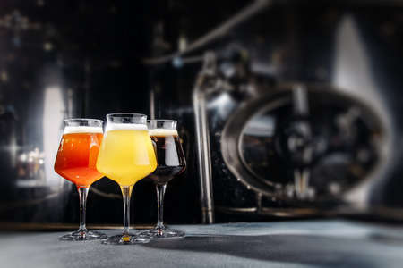 Three beer glasses at the dark background.の写真素材