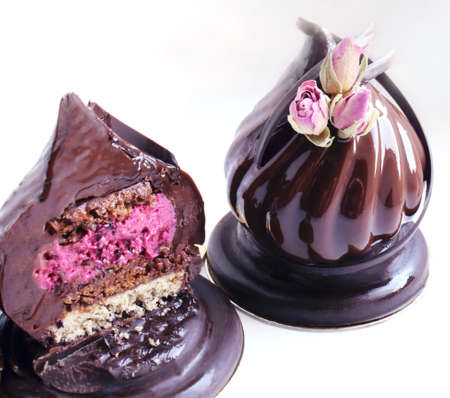 Chocolate dessert with dried roses and chocolate decoration on white background cutの写真素材