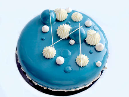 Blue and white cake with white chocolate and mirror glaze on white backgroundの写真素材