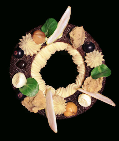 Rustic Paris Brest dessert ring with apple, berries and meringue isolated on black backgroundの写真素材