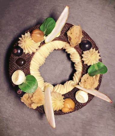 Paris Brest dessert ring with apple, berries and meringue on rustic dark backgroundの写真素材