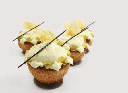 Orchid lemon and chocolate cream puffs on shady background