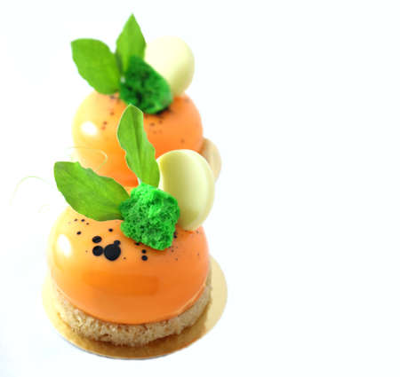 Orange carrot cake with leaves and white chocolateの写真素材