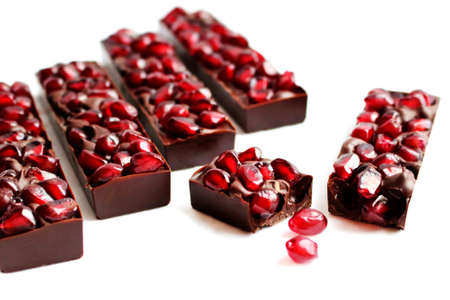 Pomegranate dark chocolate bars on white backgroundの写真素材