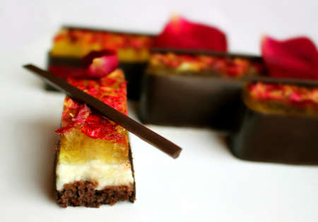 Lemon and chocolate dessert with rose petals on white backgroundの写真素材