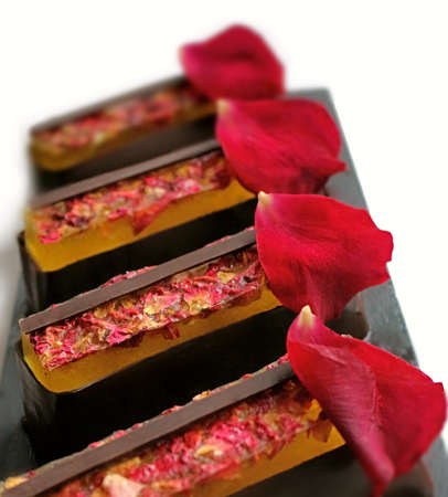 Lemon jelly and chocolate desserts with fresh edible rose petalsの写真素材