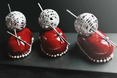 Red christmas berry desserts with silver wool ball decoration and brownieの写真素材