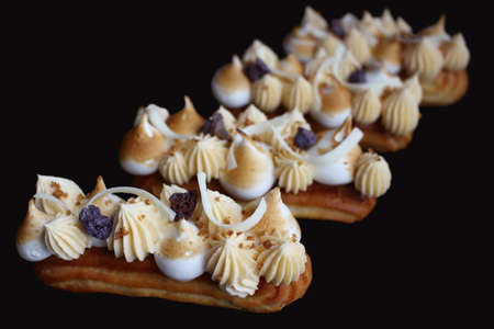 Lemon pie eclairs with purple crumble, citrus ganache and toasted meringueの写真素材