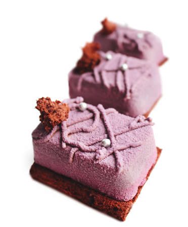 Purple textured fruit dessert on brownie base with chocolate sponge and silver sprinklesの写真素材