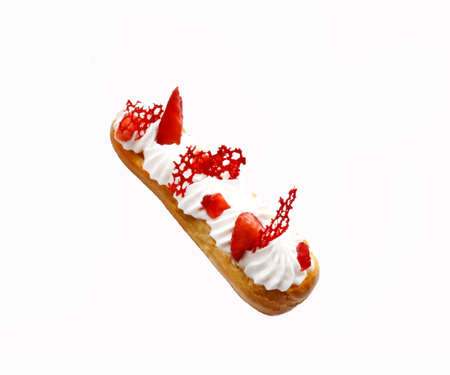 Strawberries and cream eclairs with fresh berries and red lace tuile on white backgroundの写真素材