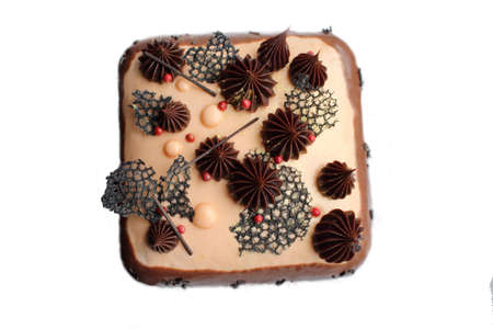 Stylish chocolate and caramel cake with ganache, pink pepper and black lace