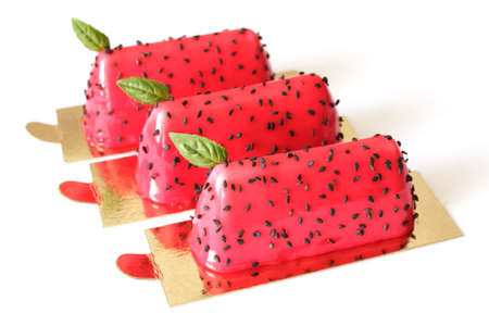 Red watermelon glazed desserts with black sesame seeds and basil leavesの写真素材