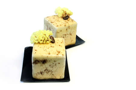 Coffee cube desserts with coffee bean and spring flower isolated on white backgroundの写真素材