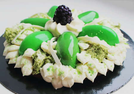 Green flower cake with cream, microwave pistachio sponge and blackberryの写真素材