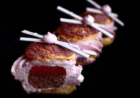 Sliced lavender profiterole with chocolate and meringue decorationsの写真素材