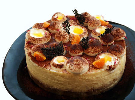 New York cheesecake with cocoa and physalis on black plateの写真素材