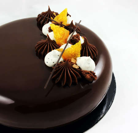 Shiny chocolate cake with oranges, chocolate ganache and whipped white chocolate creamの写真素材