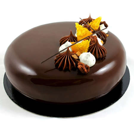 Shiny round chocolate cake with oranges, chocolate ganache and whipped white chocolate creamの写真素材