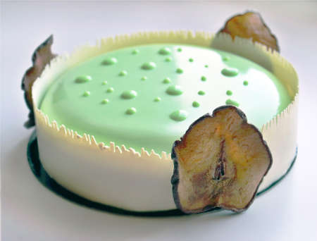 Sensual light green pear cake with white chocolate border and dried pearsの写真素材
