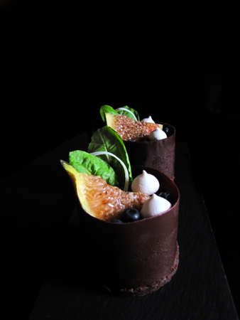 Fig and beets desserts beet leaves, blueberries, meringues and chocolate borderの写真素材