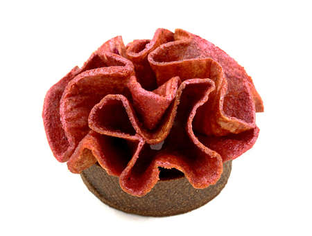 Red fruit leather ruffled tart on white backgroundの写真素材