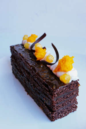 Traditional Sacher cake with apricot pieces and orange microwave sponge decorationの写真素材
