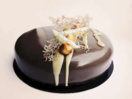 Apple and caramel nutty chocolate cake on white backgroundの写真素材