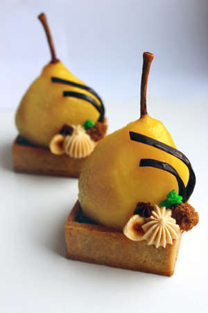 Poached pear tart with hazelnuts, soft sponge and hazenut ganacheの写真素材