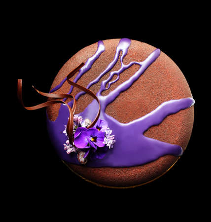 Chocolate textured spring flower cake with purple mirror glaze cover and chocolate spiral decorationの写真素材