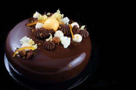 Orange chocolate cake with chocolate ganache and whipped white chocolate creamの写真素材
